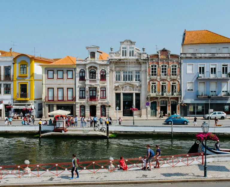 Façades colorées et bâtiments historiques bordant un canal à Aveiro, ville touristique du centre du Portugal.
